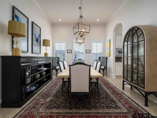a living room with fireplace furniture and a rug
