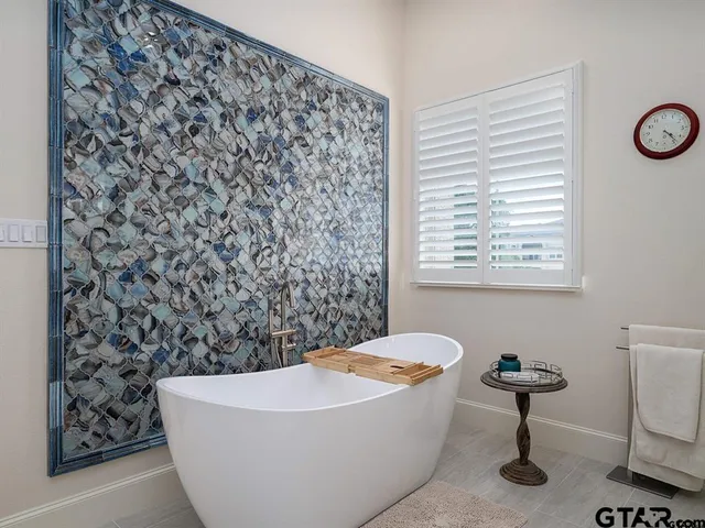 a bathroom with a bathtub and a shower