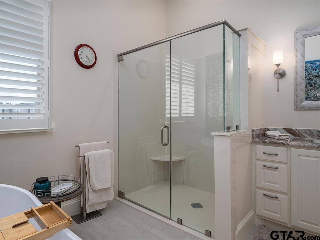 3351 Cascades Court, Unit 324 Tyler, TX 75709 - Photo 26 of 46 a bathroom with a shower a mirror and a sink