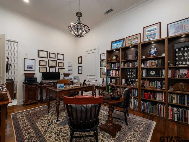 a view of a livingroom with furniture and bookshelf