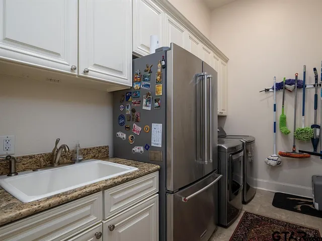 a kitchen with a refrigerator and a sink