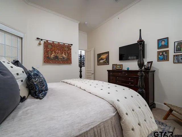 a bedroom with a bed and a flat screen tv