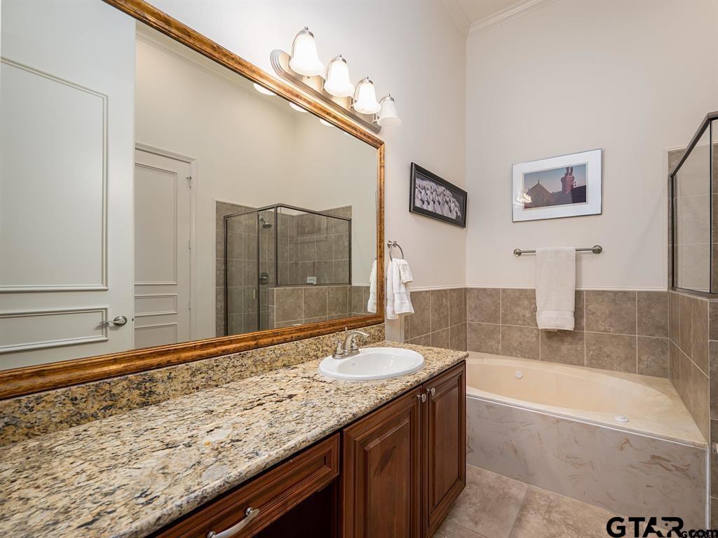 3351 Cascades Court, Unit 324 Tyler, TX 75709 - Photo 39 of 46 a bathroom with a granite countertop sink and a mirror
