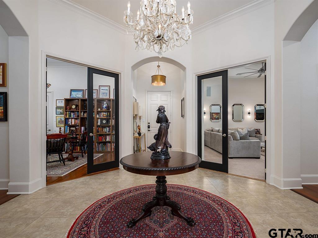 3351 Cascades Court, Unit 324 Tyler, TX 75709 - Photo 4 of 46 a living room with furniture a chandelier and a rug