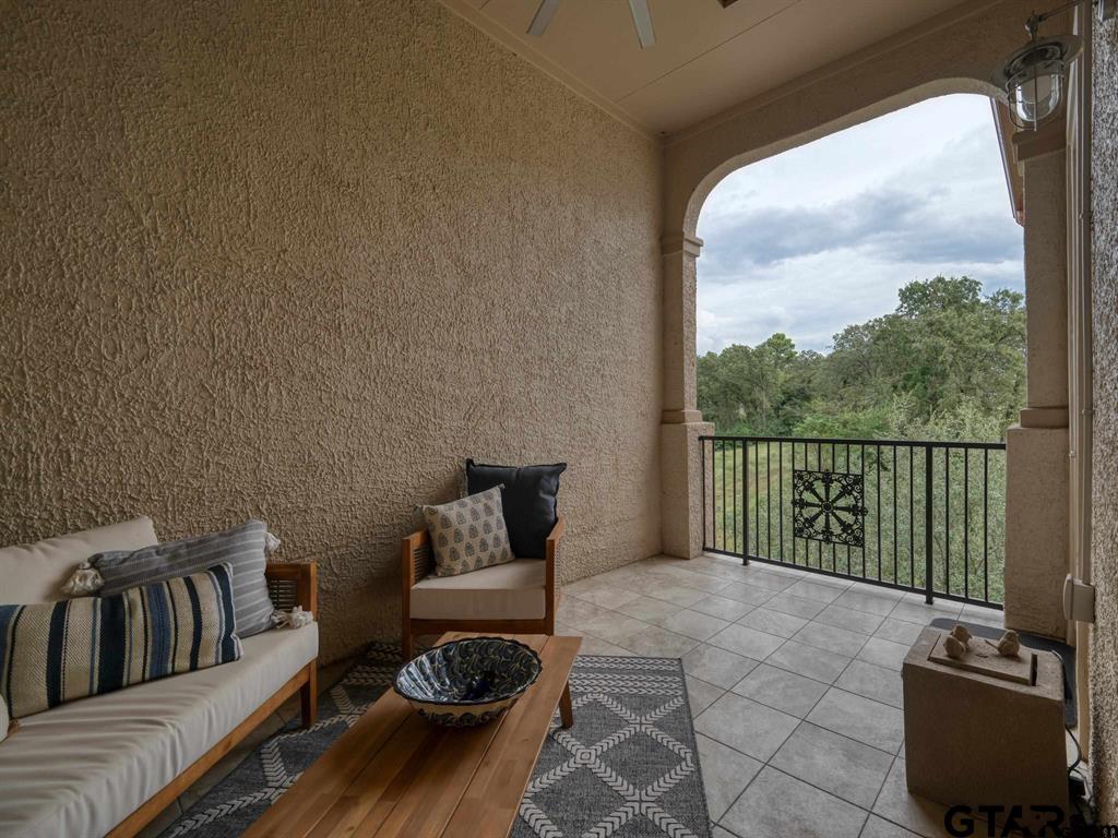 3351 Cascades Court, Unit 324 Tyler, TX 75709 - Photo 44 of 46 a living room with furniture and a floor to ceiling window