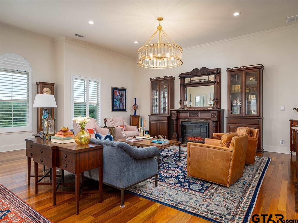 3351 Cascades Court, Unit 324 Tyler, TX 75709 - Photo 5 of 46 a living room with fireplace furniture and a chandelier