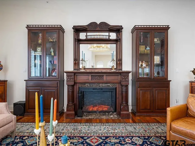 a front view of a livingroom with furniture and a fireplace