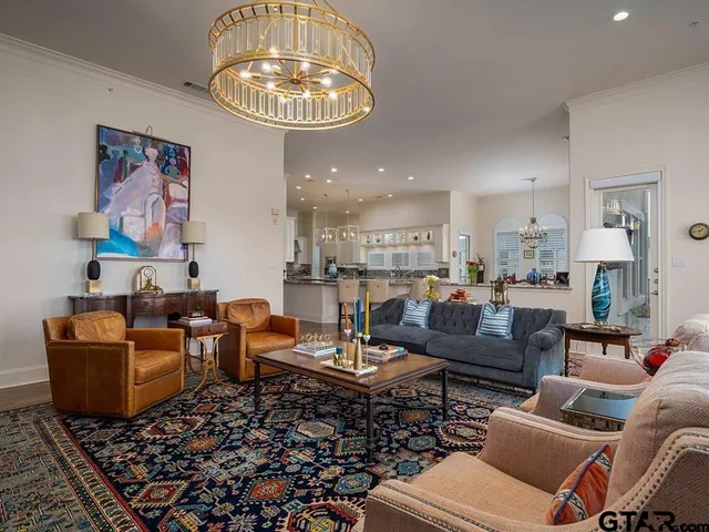 a living room with furniture and a chandelier