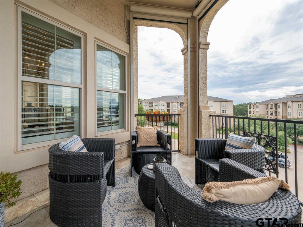 3351 Cascades Court, Unit 324 Tyler, TX 75709 - Photo 9 of 46 a living room with furniture and a floor to ceiling window