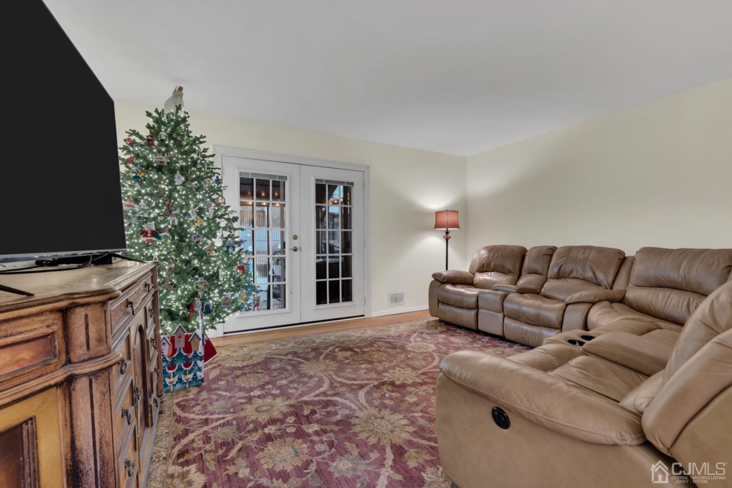 17 Temple Road, Unit 17 Old Bridge, NJ 08859 - Photo 11 of 40 a living room with furniture a flat screen tv and a potted plant