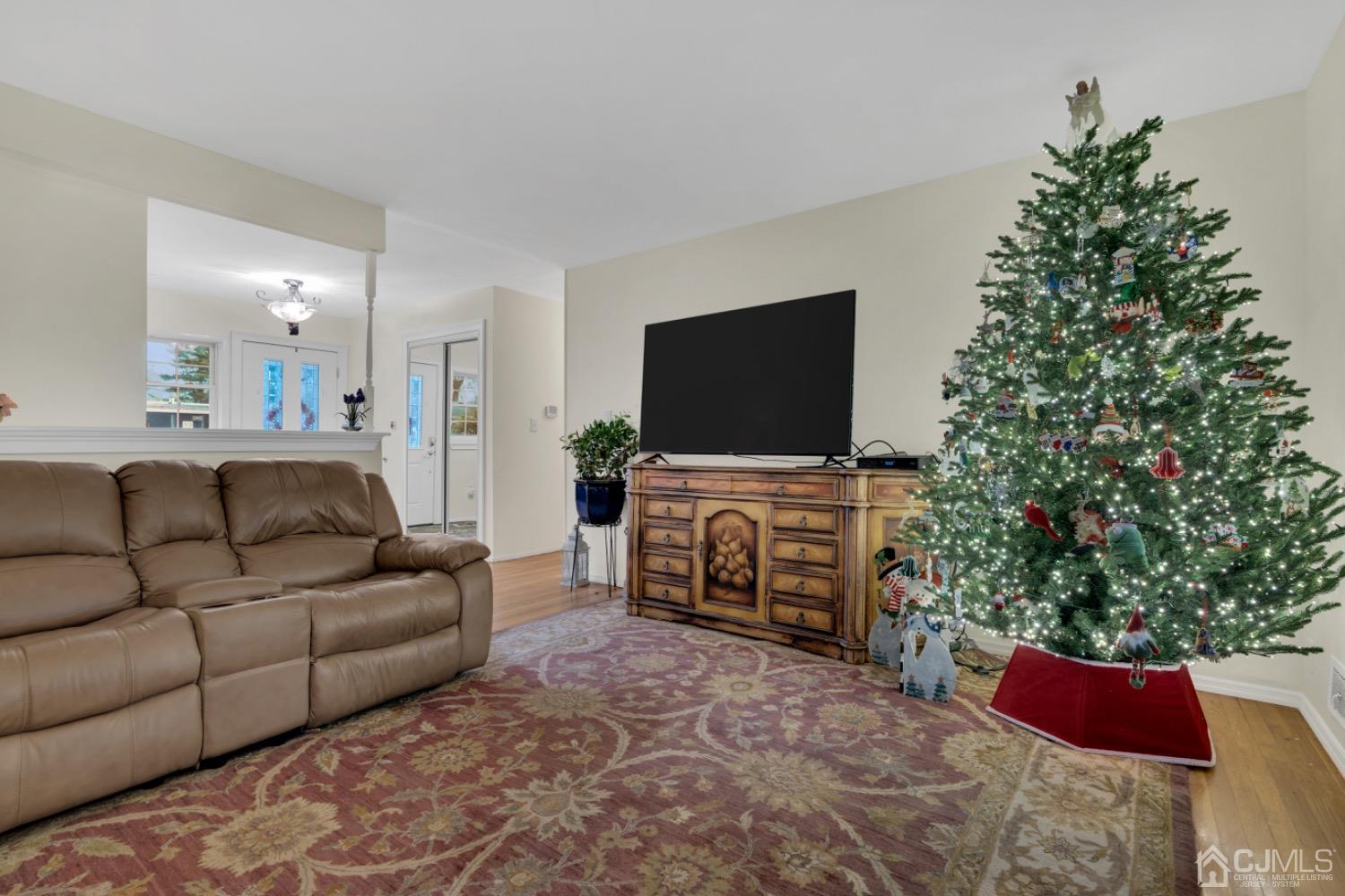 17 Temple Road, Unit 17 Old Bridge, NJ 08859 - Photo 13 of 40 a living room with furniture a flat screen tv and a potted plant