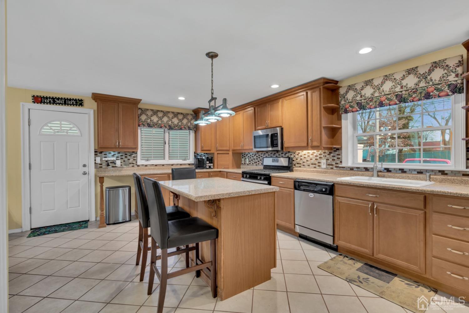 17 Temple Road, Unit 17 Old Bridge, NJ 08859 - Photo 17 of 40 a kitchen with a table chairs refrigerator and cabinets
