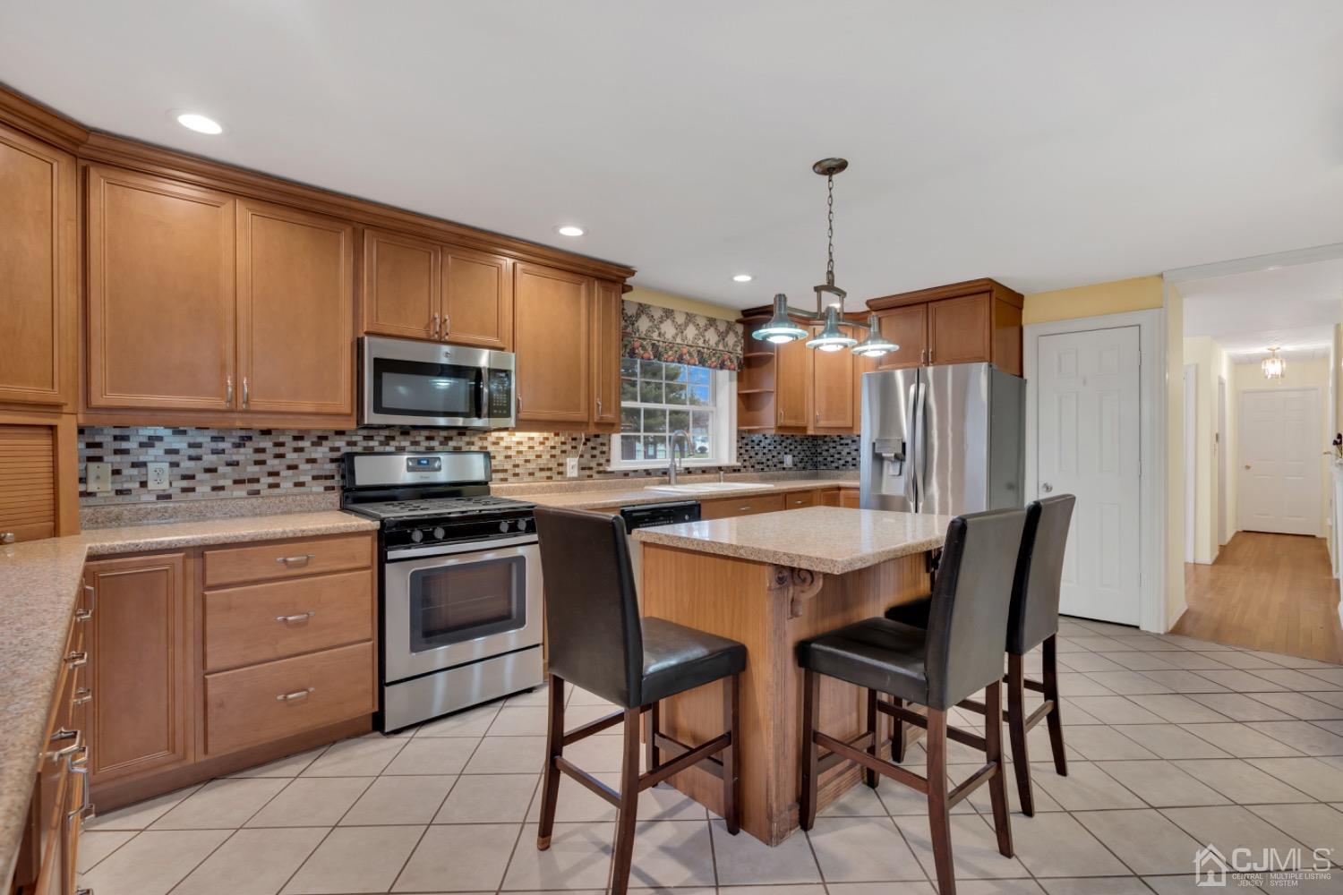 17 Temple Road, Unit 17 Old Bridge, NJ 08859 - Photo 20 of 40 a kitchen with stainless steel appliances granite countertop a stove top oven a sink dishwasher and a refrigerator