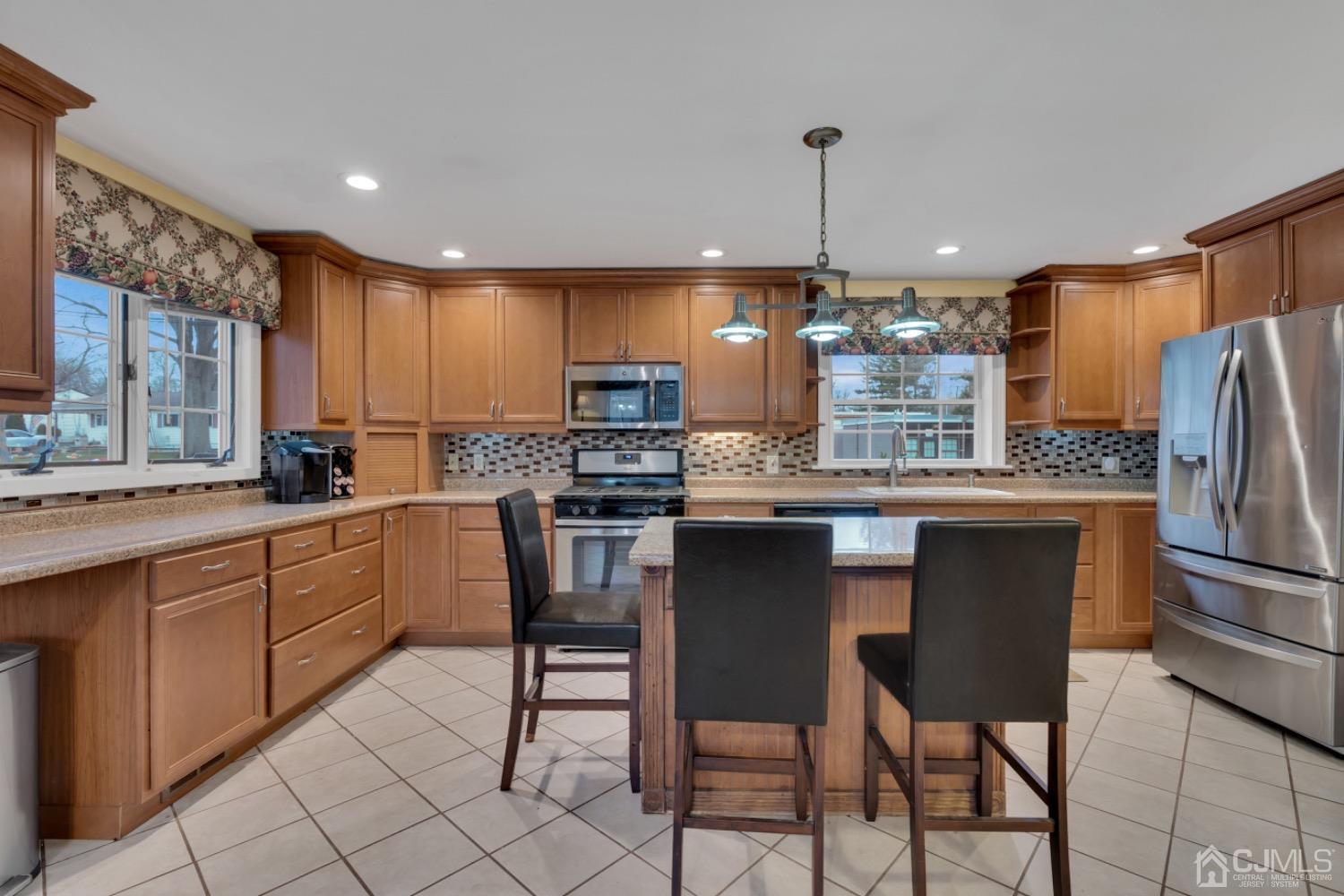 17 Temple Road, Unit 17 Old Bridge, NJ 08859 - Photo 21 of 40 a kitchen with refrigerator a sink and chairs