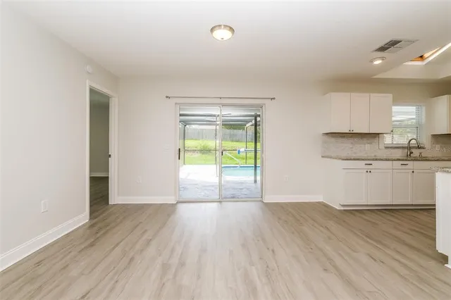 a kitchen with stainless steel appliances white cabinets and a granite counter top