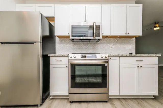 a kitchen with a sink stove and refrigerator