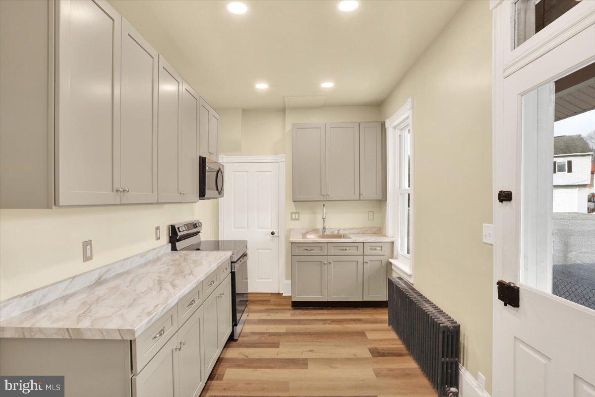 16 South Hull Street Reading, PA 19608 - Photo 9 of 30 a kitchen with a sink stove and cabinets