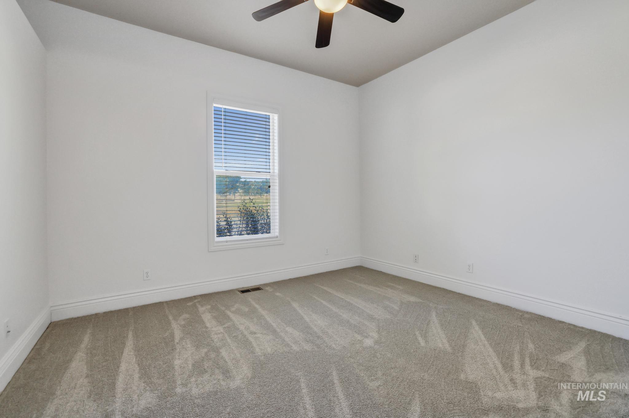 1301 Kanaka Rapids Road Buhl, ID 83316 - Photo 35 of 50 Spacious room with light gray carpet, white baseboards, and a single window with horizontal blinds
