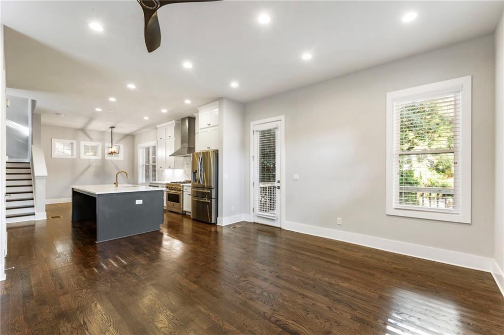 1819 Huntington Hills Lane Northwest Atlanta, GA 30309 - Photo 12 of 53 a large kitchen with stainless steel appliances granite countertop a large counter top a wooden floors and a large window