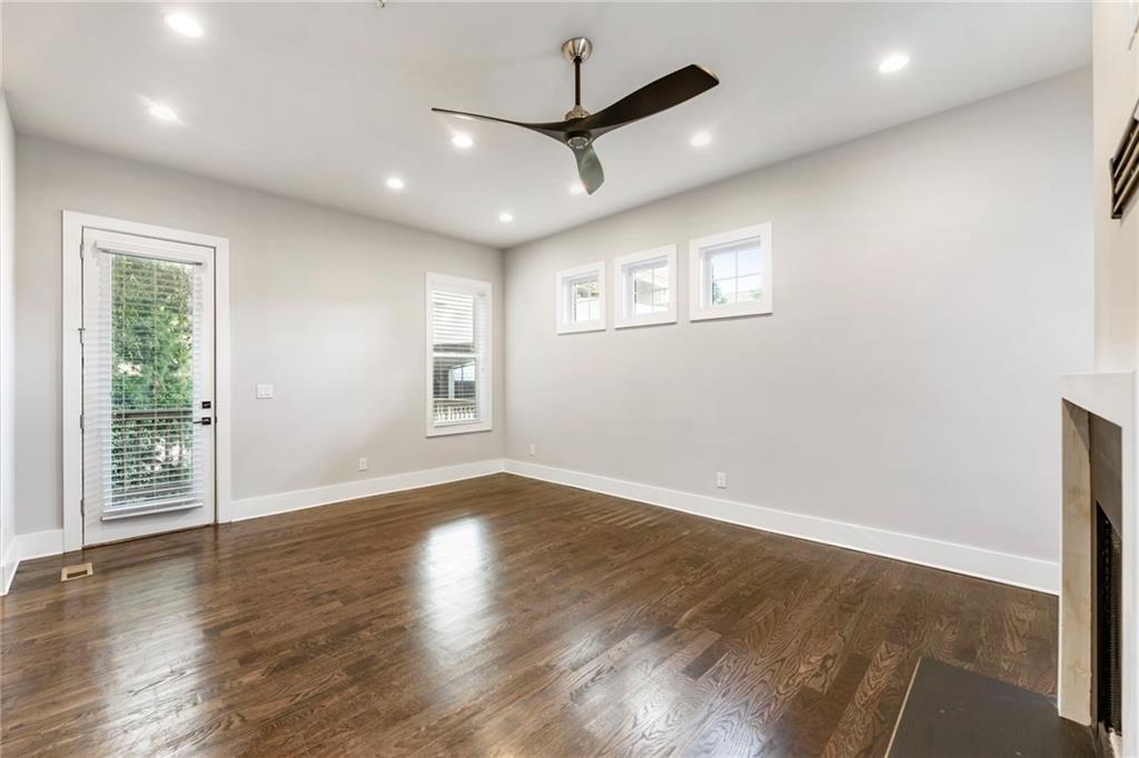 1819 Huntington Hills Lane Northwest Atlanta, GA 30309 - Photo 13 of 53 a view of an empty room with wooden floor and a window