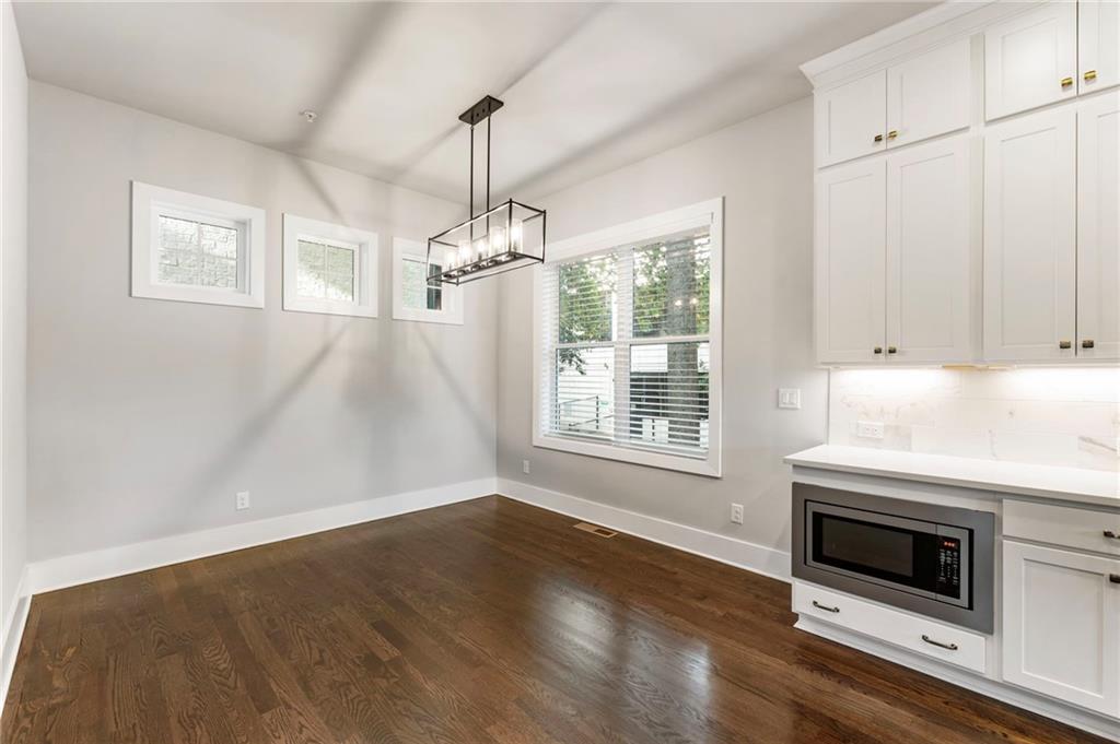 1819 Huntington Hills Lane Northwest Atlanta, GA 30309 - Photo 26 of 53 a kitchen with granite countertop a stove and a microwave
