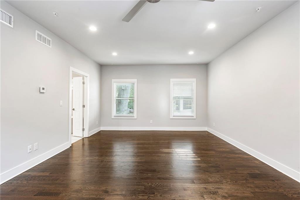 1819 Huntington Hills Lane Northwest Atlanta, GA 30309 - Photo 32 of 53 an empty room with wooden floor and windows