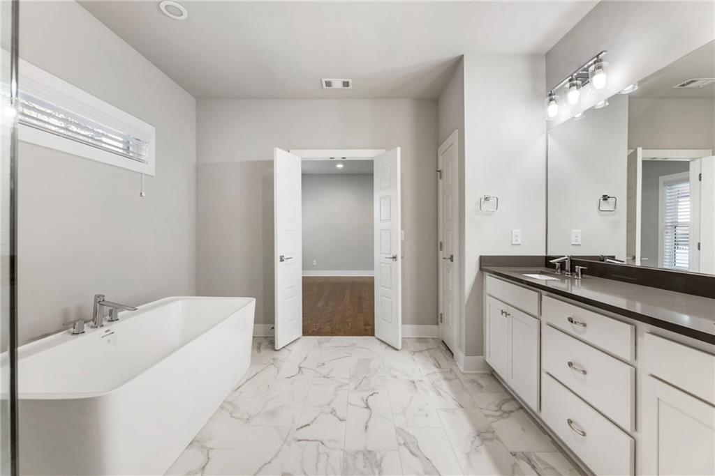 1819 Huntington Hills Lane Northwest Atlanta, GA 30309 - Photo 35 of 53 a spacious bathroom with a bathtub sink double and mirror