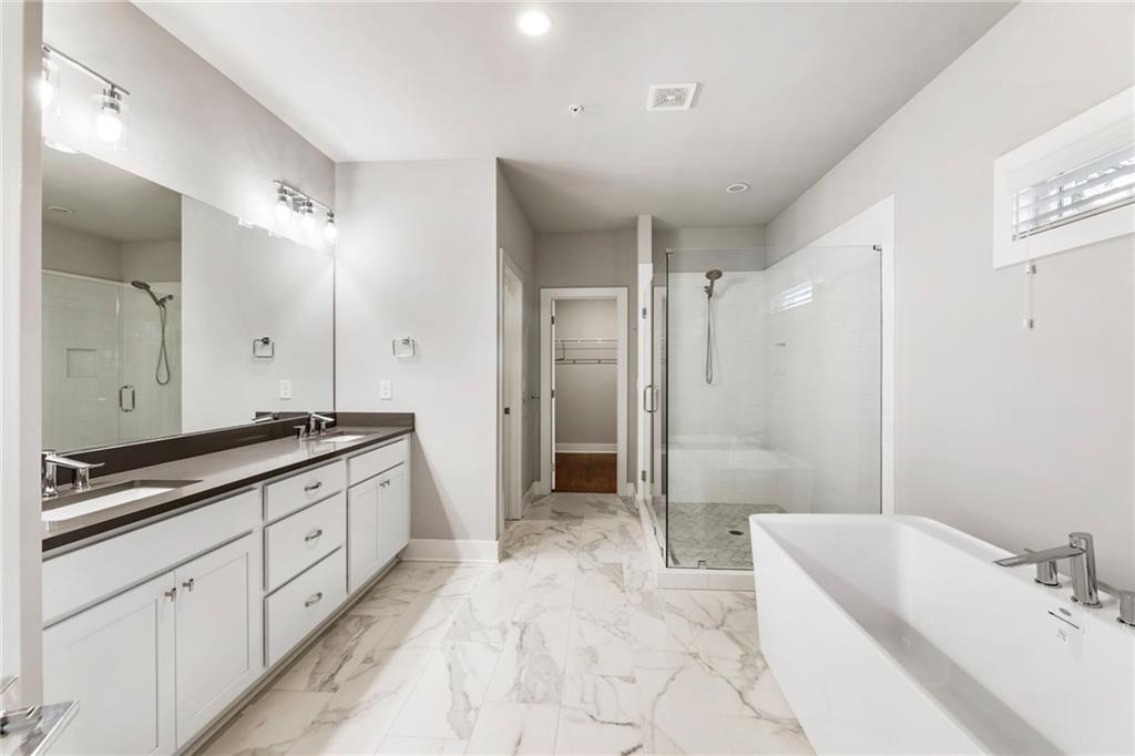 1819 Huntington Hills Lane Northwest Atlanta, GA 30309 - Photo 37 of 53 a spacious bathroom with a tub sink shower and mirror