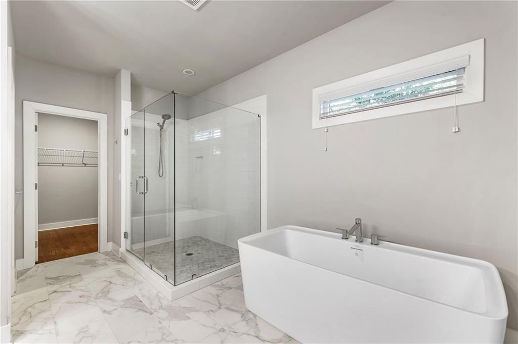 1819 Huntington Hills Lane Northwest Atlanta, GA 30309 - Photo 38 of 53 a bathroom with a bathtub and a shower