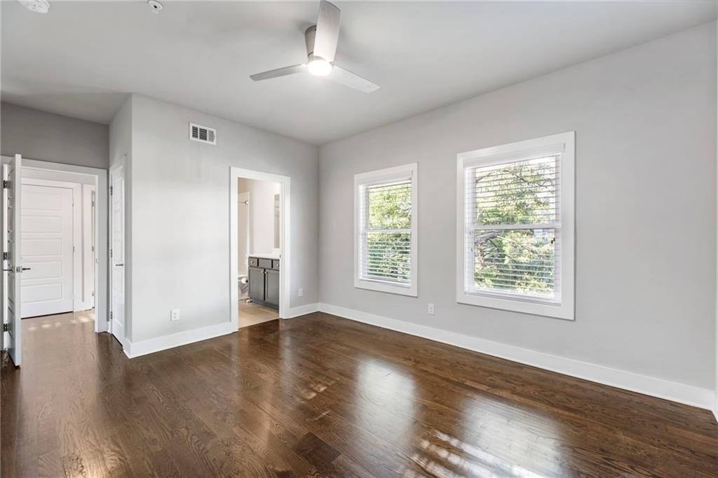 1819 Huntington Hills Lane Northwest Atlanta, GA 30309 - Photo 43 of 53 a view of an empty room with wooden floor and a window