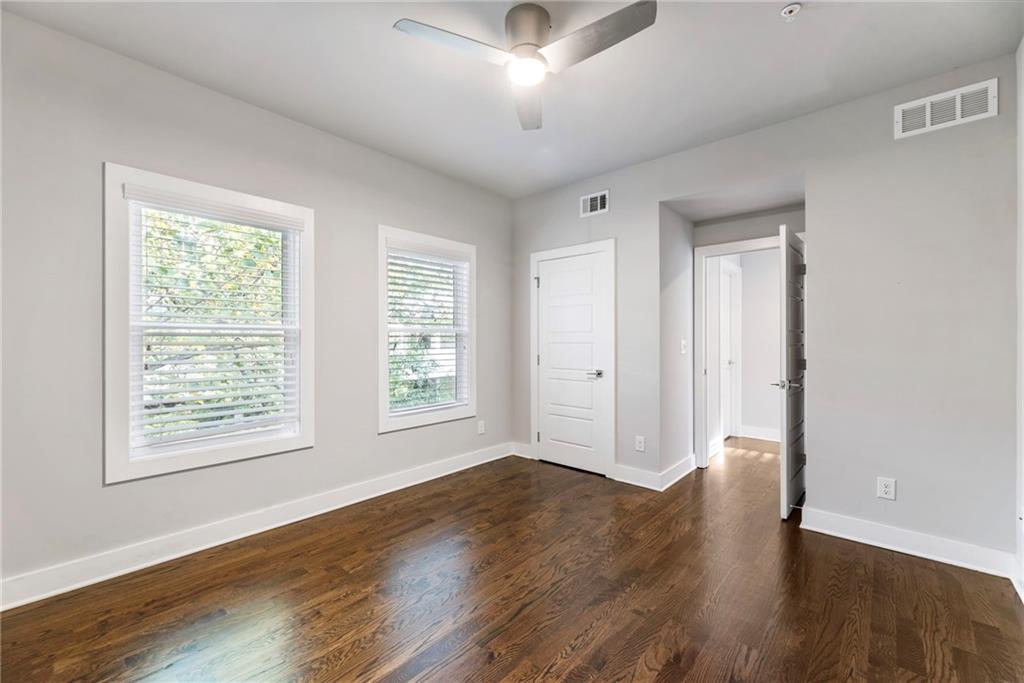 1819 Huntington Hills Lane Northwest Atlanta, GA 30309 - Photo 47 of 53 a view of an empty room with wooden floor and a window