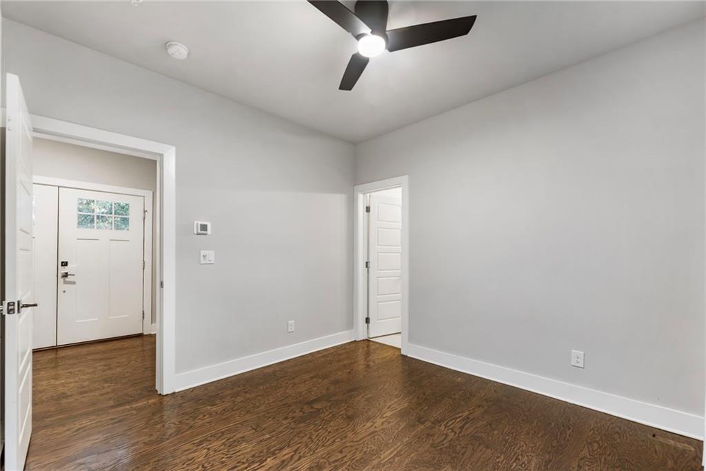 1819 Huntington Hills Lane Northwest Atlanta, GA 30309 - Photo 7 of 53 an empty room with wooden floor and windows