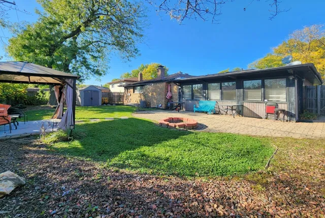 a view of a house with a backyard and a patio