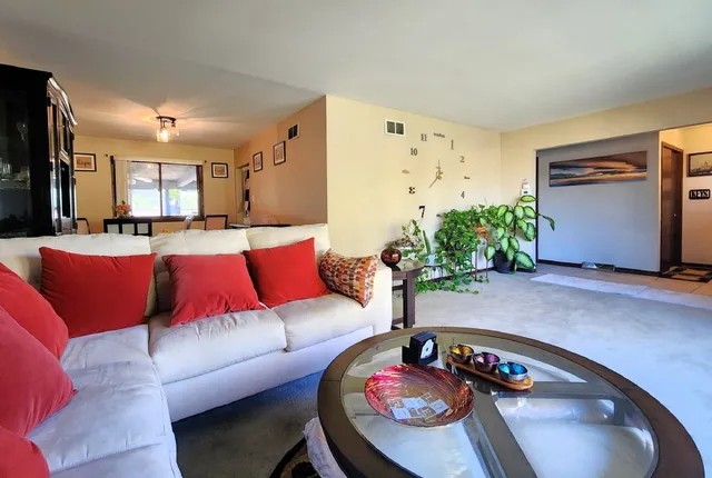 a living room with furniture and a fireplace
