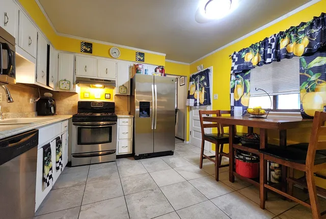 a kitchen with stainless steel appliances and cabinets