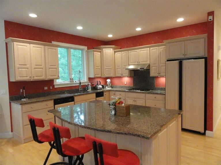 21 Greensward Road Mashpee, MA 02649 - Photo 2 of 22 a kitchen with stainless steel appliances granite countertop a sink chairs and a refrigerator