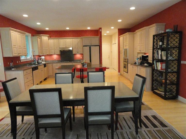 21 Greensward Road Mashpee, MA 02649 - Photo 3 of 22 a dining room with stainless steel appliances a dining table chairs and a refrigerator