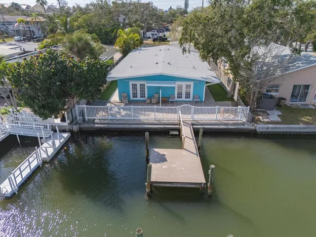 a aerial view of a house with swimming pool and lake view