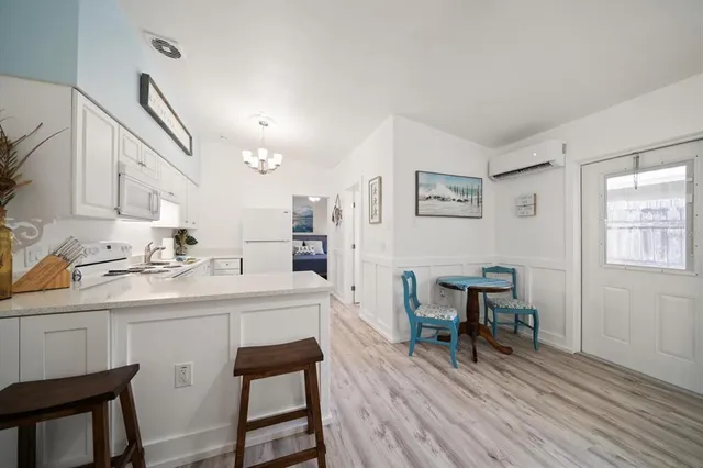 a kitchen with a sink cabinets and wooden floor