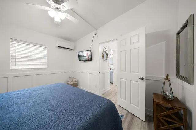a bedroom with a bed and a chandelier