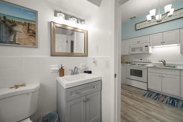 a kitchen with stainless steel appliances a refrigerator sink and cabinets