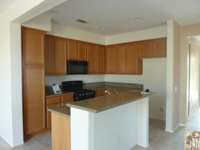 37185 Wakefield Street Indio, CA 92203 - Photo 1 of 8 a kitchen with a sink a stove a refrigerator and cabinets