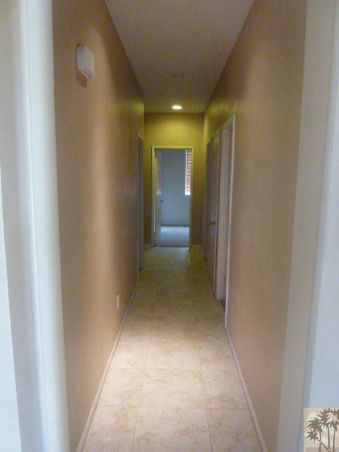 37185 Wakefield Street Indio, CA 92203 - Photo 7 of 8 a view of a hallway with wooden shelves