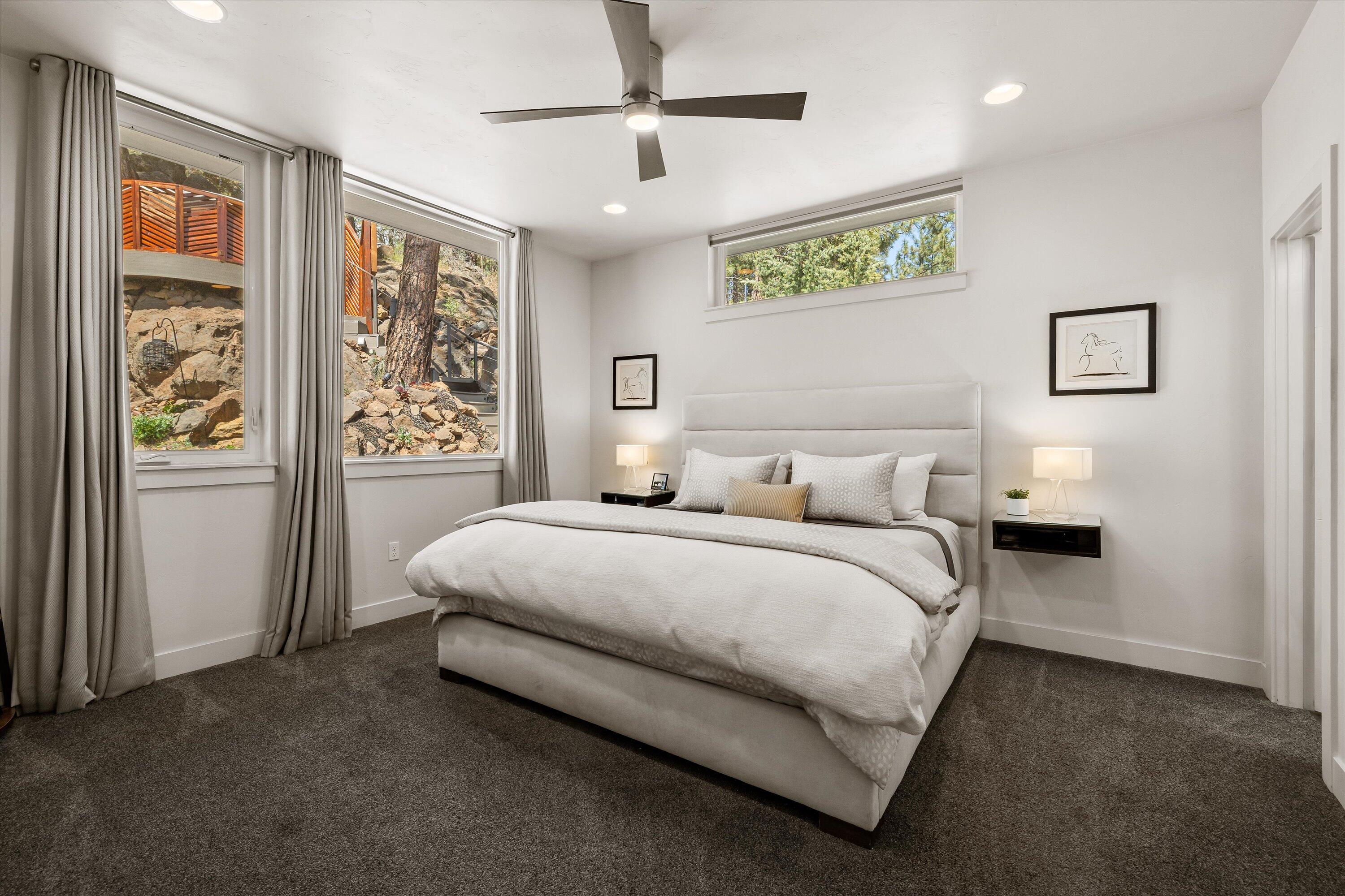 19504 Southwest Century Drive Bend, OR 97702 - Photo 22 of 58 a spacious bedroom with a bed painting on the wall and a window