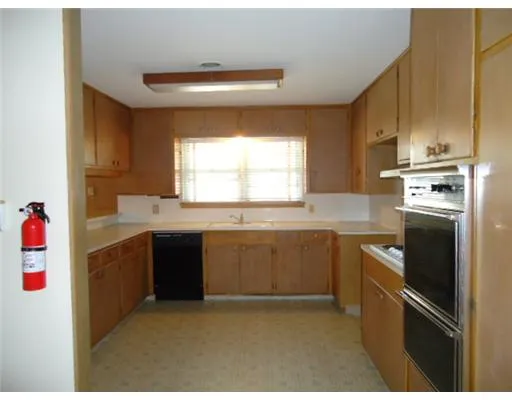 a kitchen with granite countertop a sink stainless steel appliances and cabinets