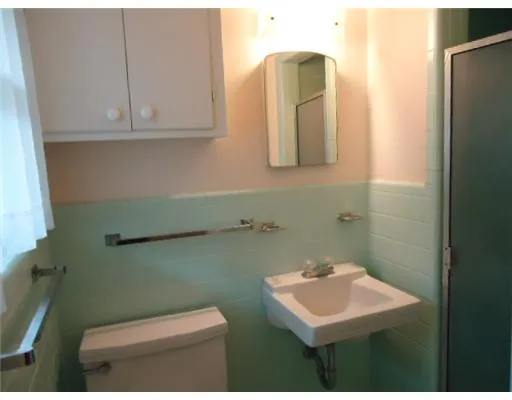 a bathroom with a sink a toilet and mirror