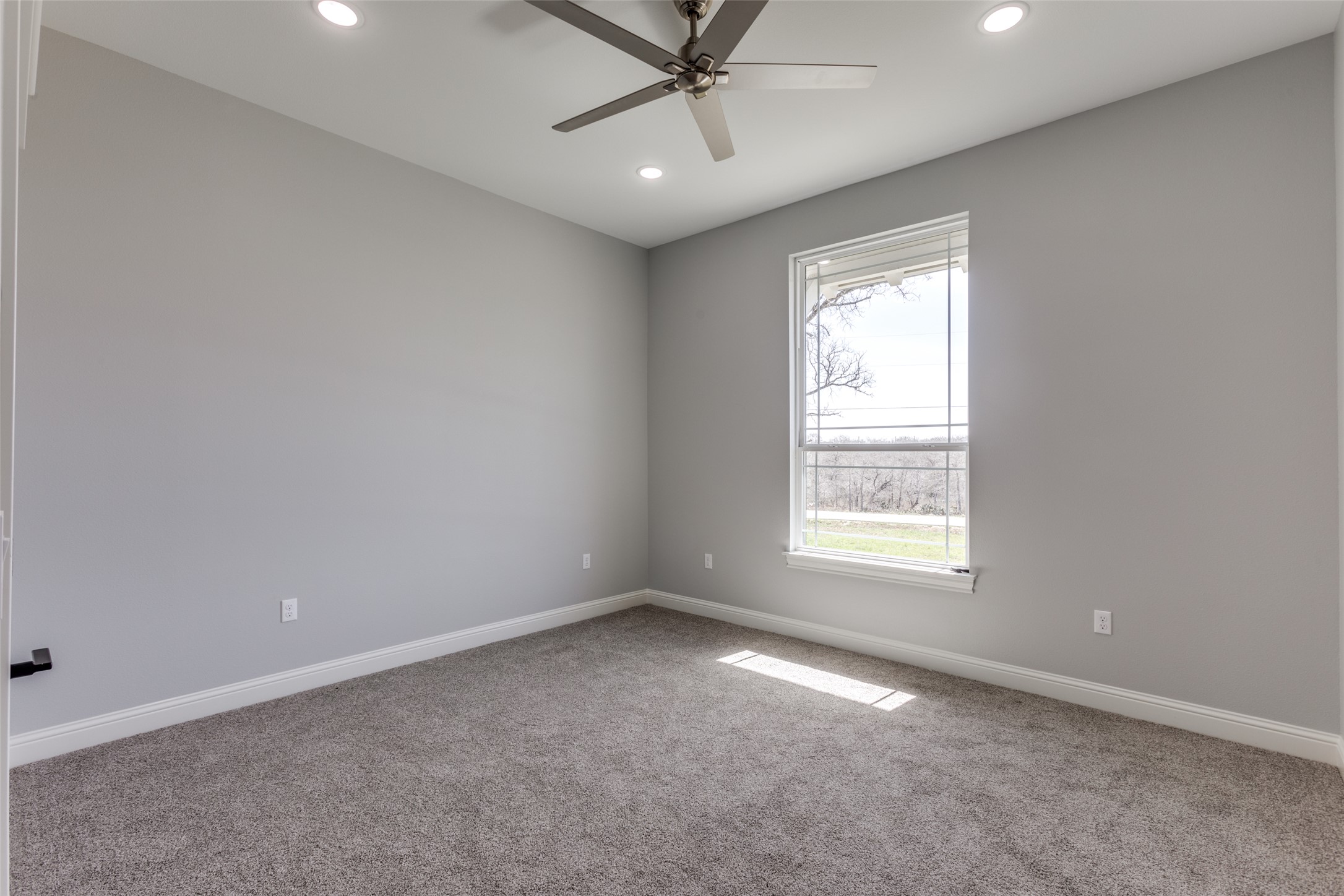 485 Post Oak Gonzales, TX 78629 - Photo 17 of 38 an empty room with a window and a fan
