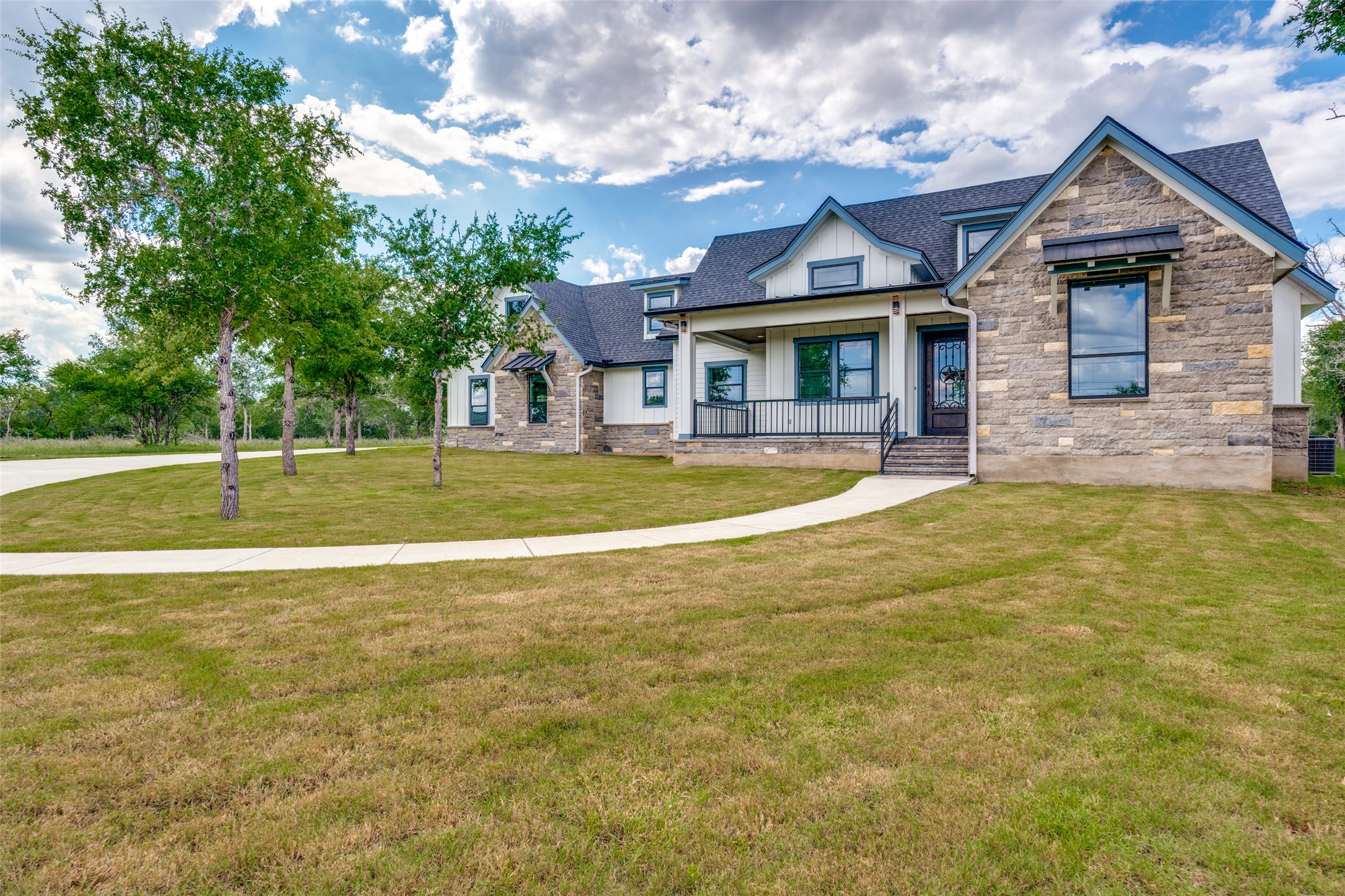 485 Post Oak Gonzales, TX 78629 - Photo 2 of 38 a front view of a house with a big yard and chandelier