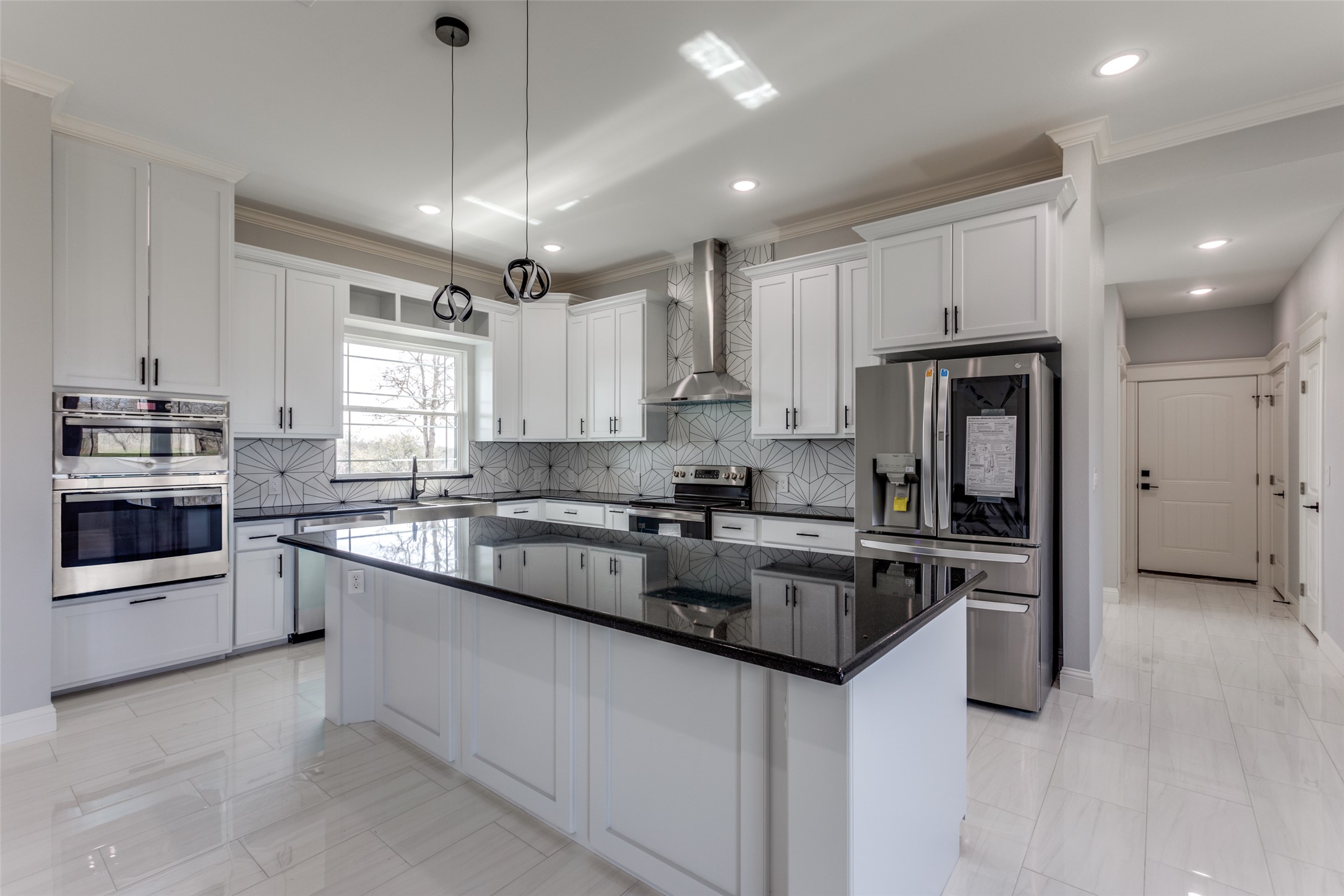 485 Post Oak Gonzales, TX 78629 - Photo 5 of 38 a kitchen with stainless steel appliances granite countertop a refrigerator a stove a sink and a microwave