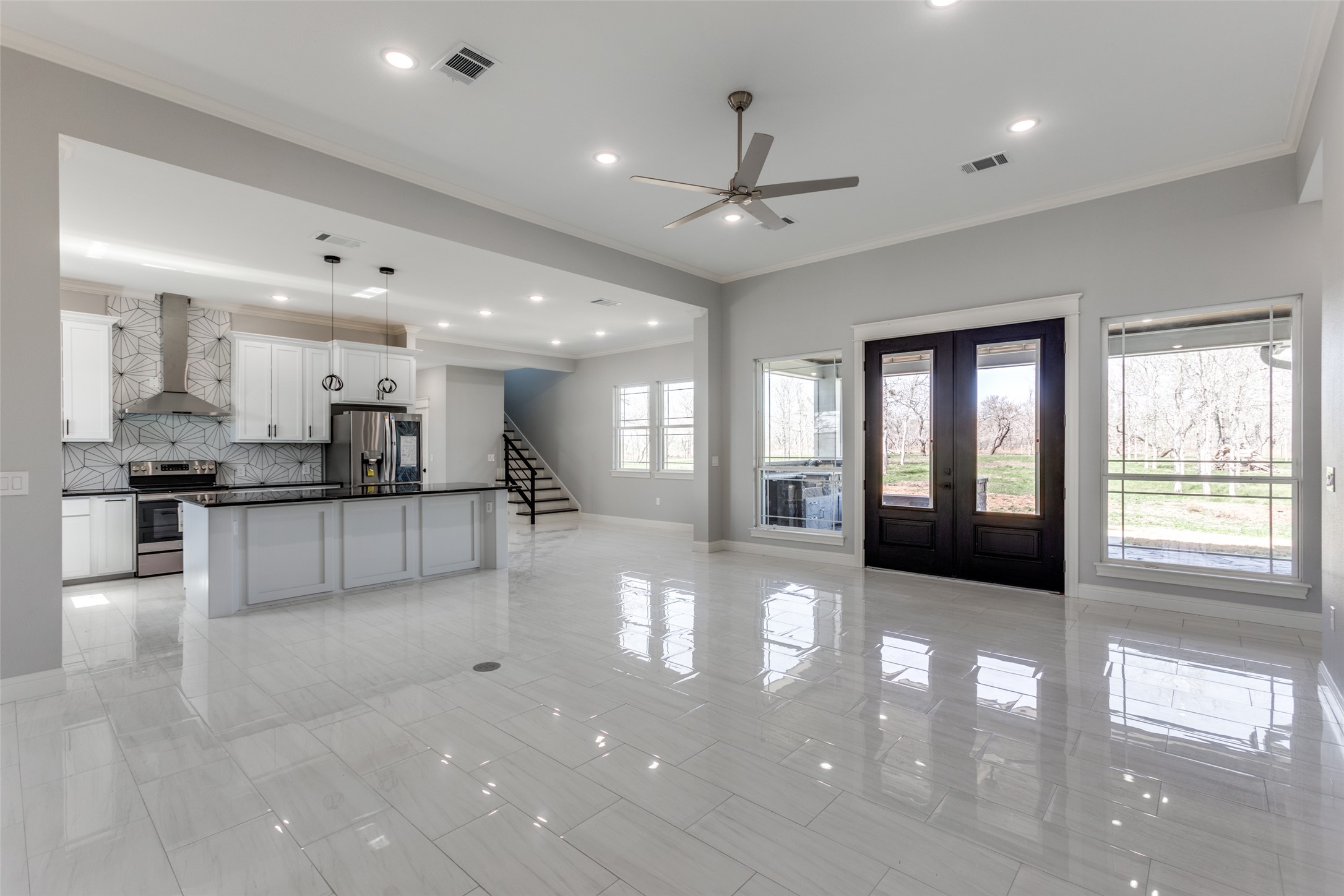 485 Post Oak Gonzales, TX 78629 - Photo 10 of 38 a view of an empty room and kitchen with a large window